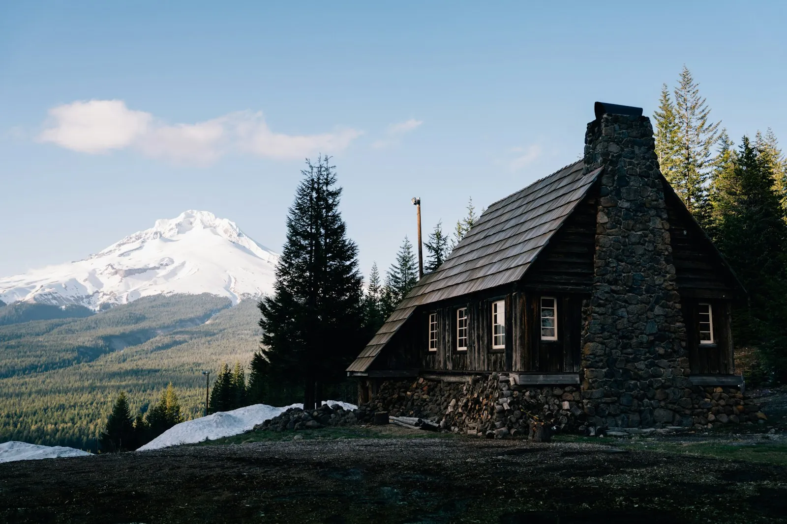 Timber lodge basecamp with mountain range behind