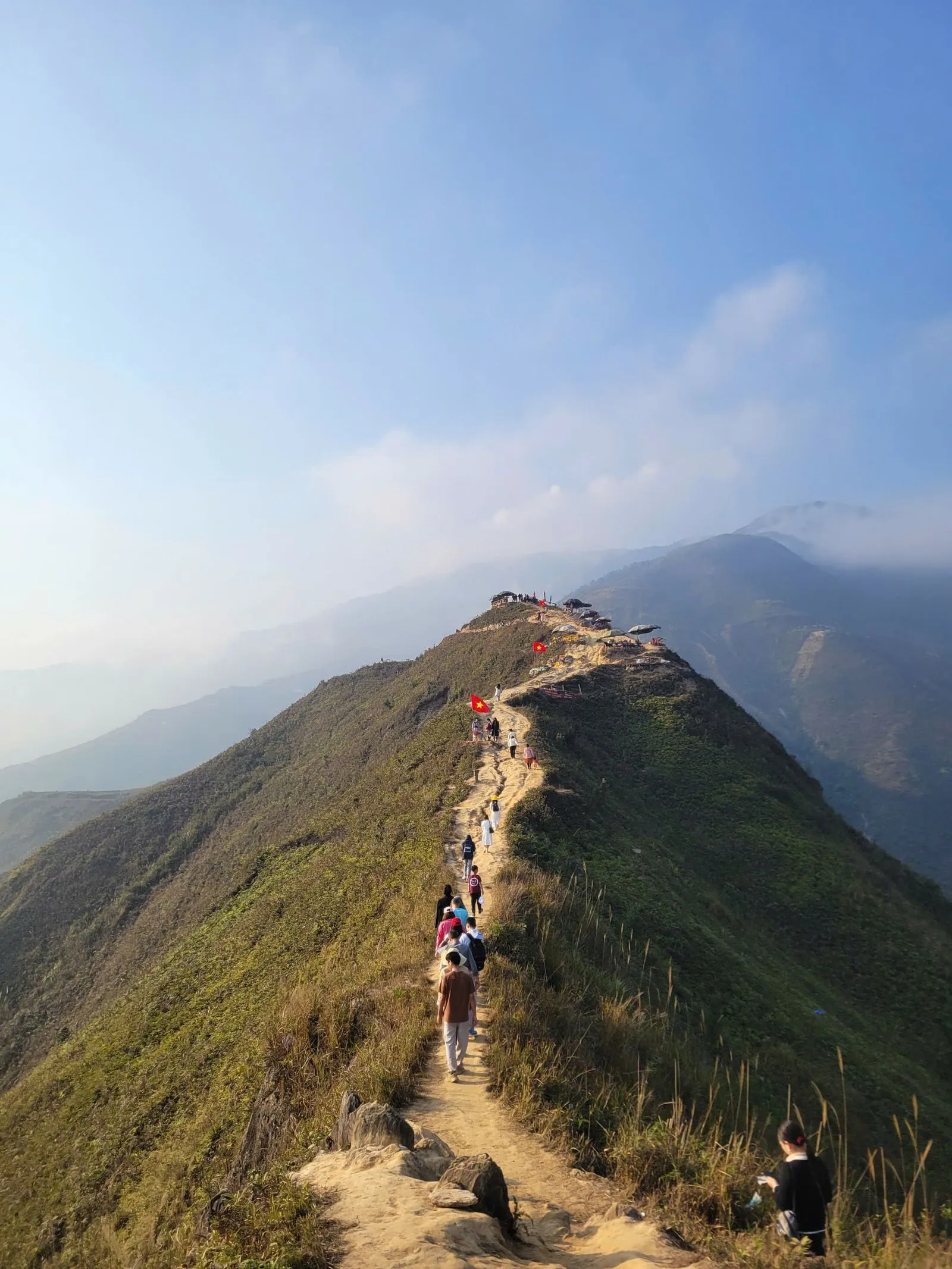 Group of hikers ascending a switchback at sunrise