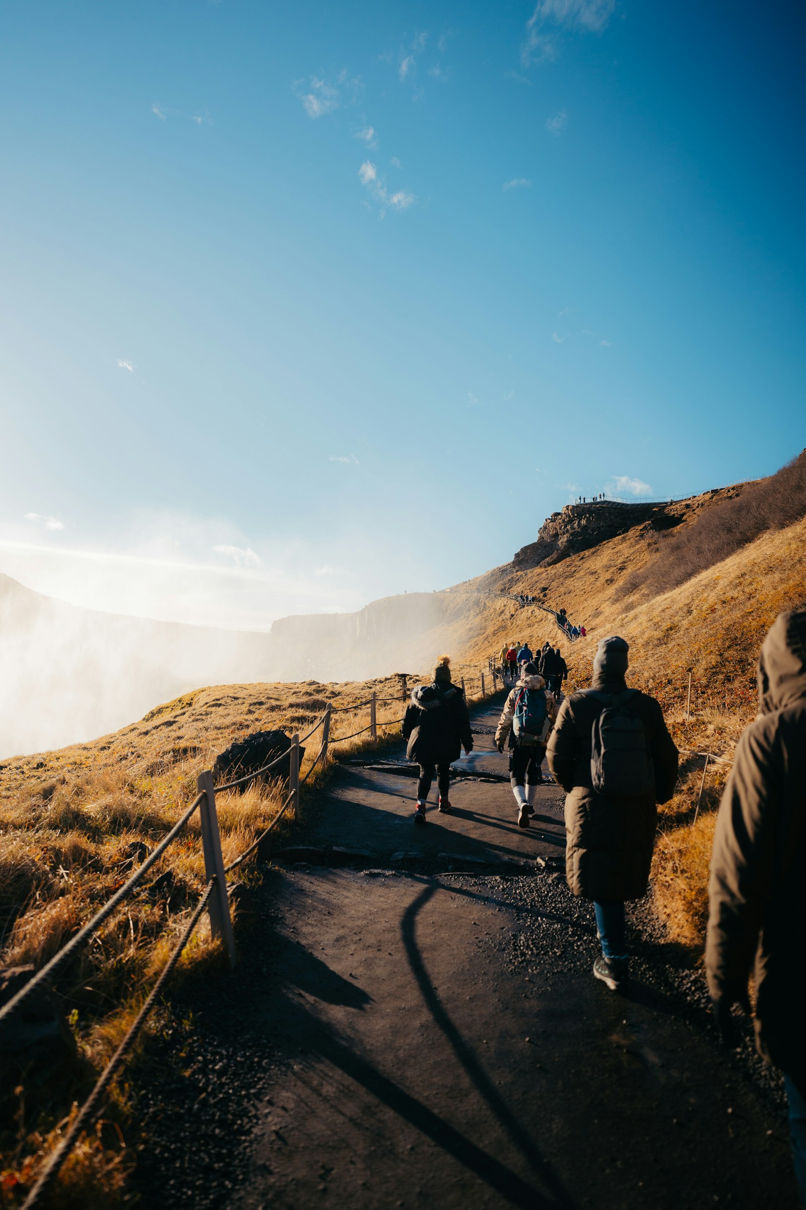 Large group of hikers pausing together on a trail